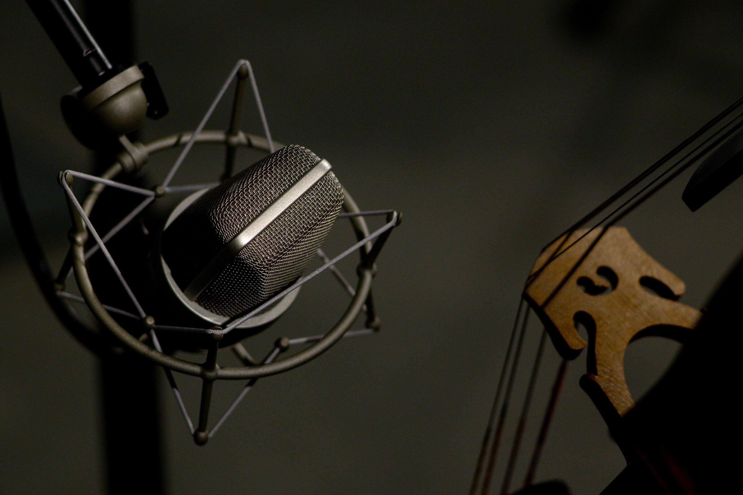 Studio microphone and cello in low light